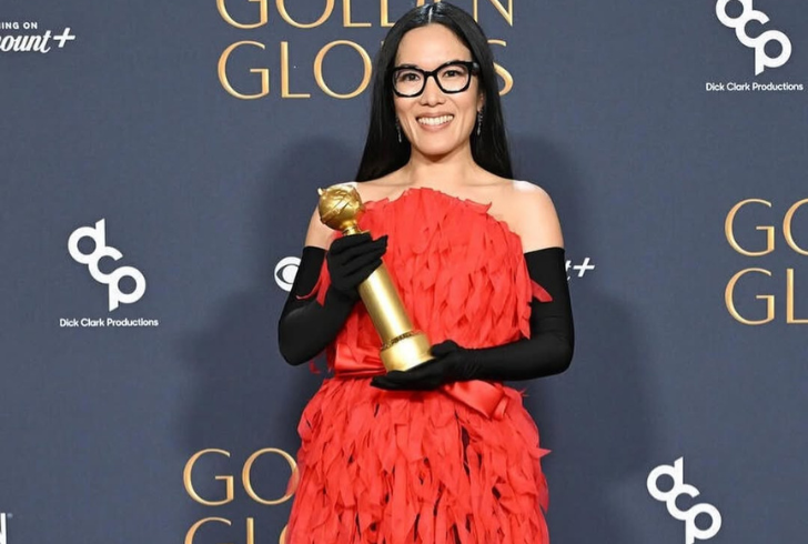 Ali Wong dazzles in a fiery red Balenciaga dress and black opera gloves.